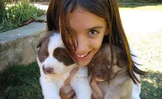 Girl holding newborn puppies