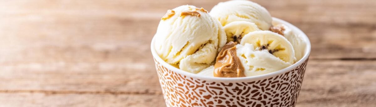 Dog-friendly ice cream with banana, yogurt, and peanut butter, in a stylish cup.