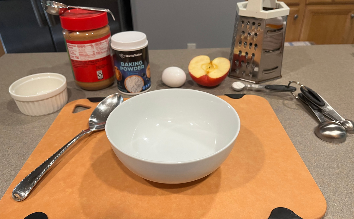 A display of all the ingredients and equipment needed to make this dog birthday cake. 