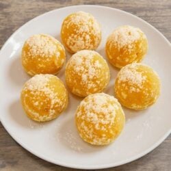 No-bake sweet potato dog treats on a plate sprinkled with coconut powder.