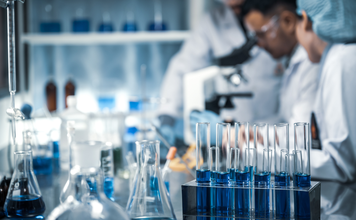 Scientists looking through a microscope in a laboratory.