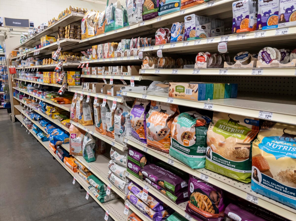 Woodinville, WA USA - circa February 2022: Angled, selective focus of the dry and wet cat food aisle inside of a Petsmart store.