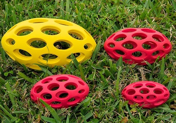 4 different sizes of the JW pet Hol-ee football for dogs compared