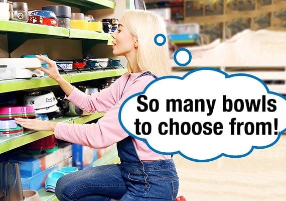 Blond-haired woman customer looking at dog bowls on the shelf of a pet store