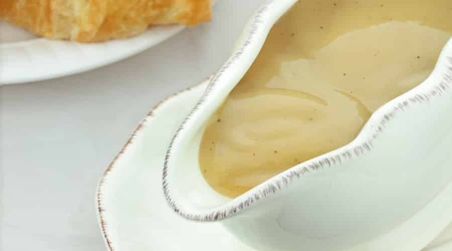 Boat of Dressing on a Table.