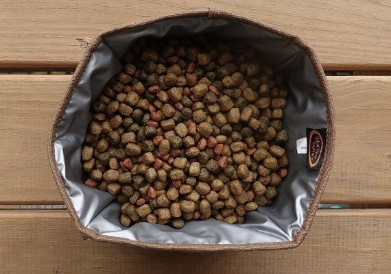 Canvas collapsible dog bowl filled with dry dog food