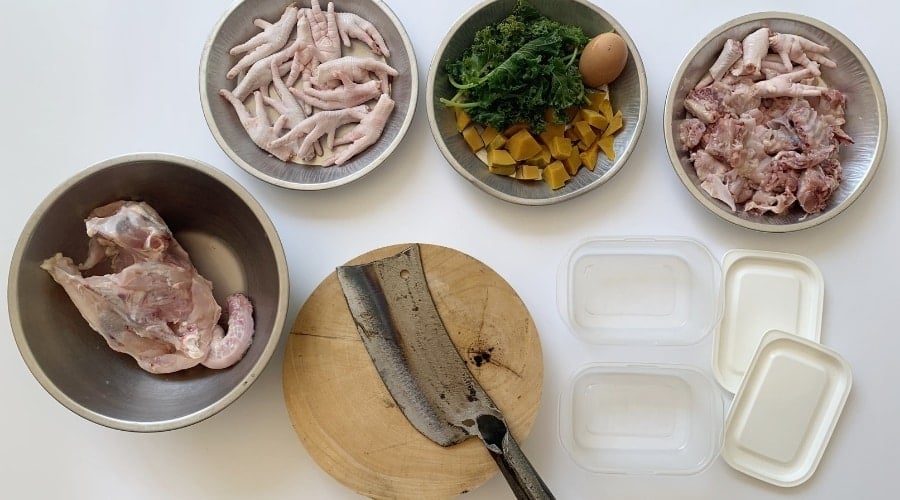 Chopped kale in bowl with raw meat
