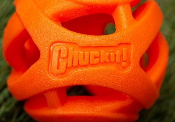 Close up on Chuckit! Breath Right orange dog tennis ball open lattice structure