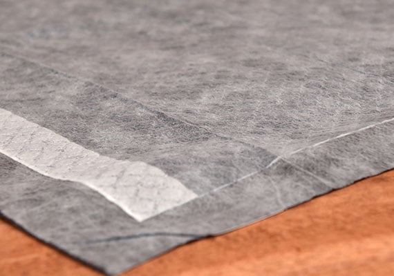Close up on absorbent gray surface of bulldogology carbon tech puppy training pad - winner of best premium pee pads for dogs