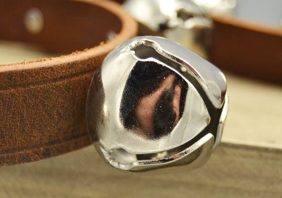 Close up on hole in the jingle bell of a dog doorknob