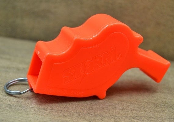 Close up on storm alert safety whistle.
