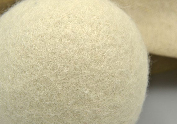 Close up on the surface of a wool dryer ball with trapped pet hair