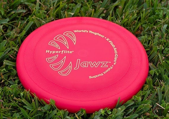 Hyperflite Jawz frisbee after it landed on grass in park