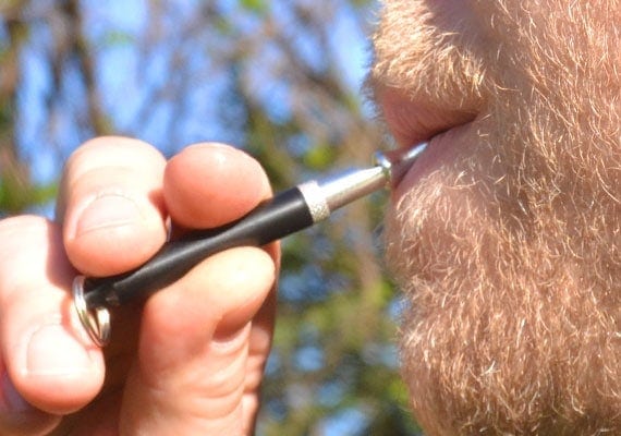 Man blowing on Remington Professional ultrasonic dog whistle.