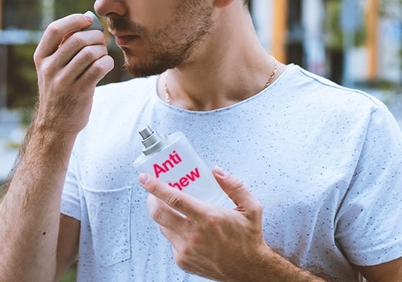Man smelling the cap of anti chew spray