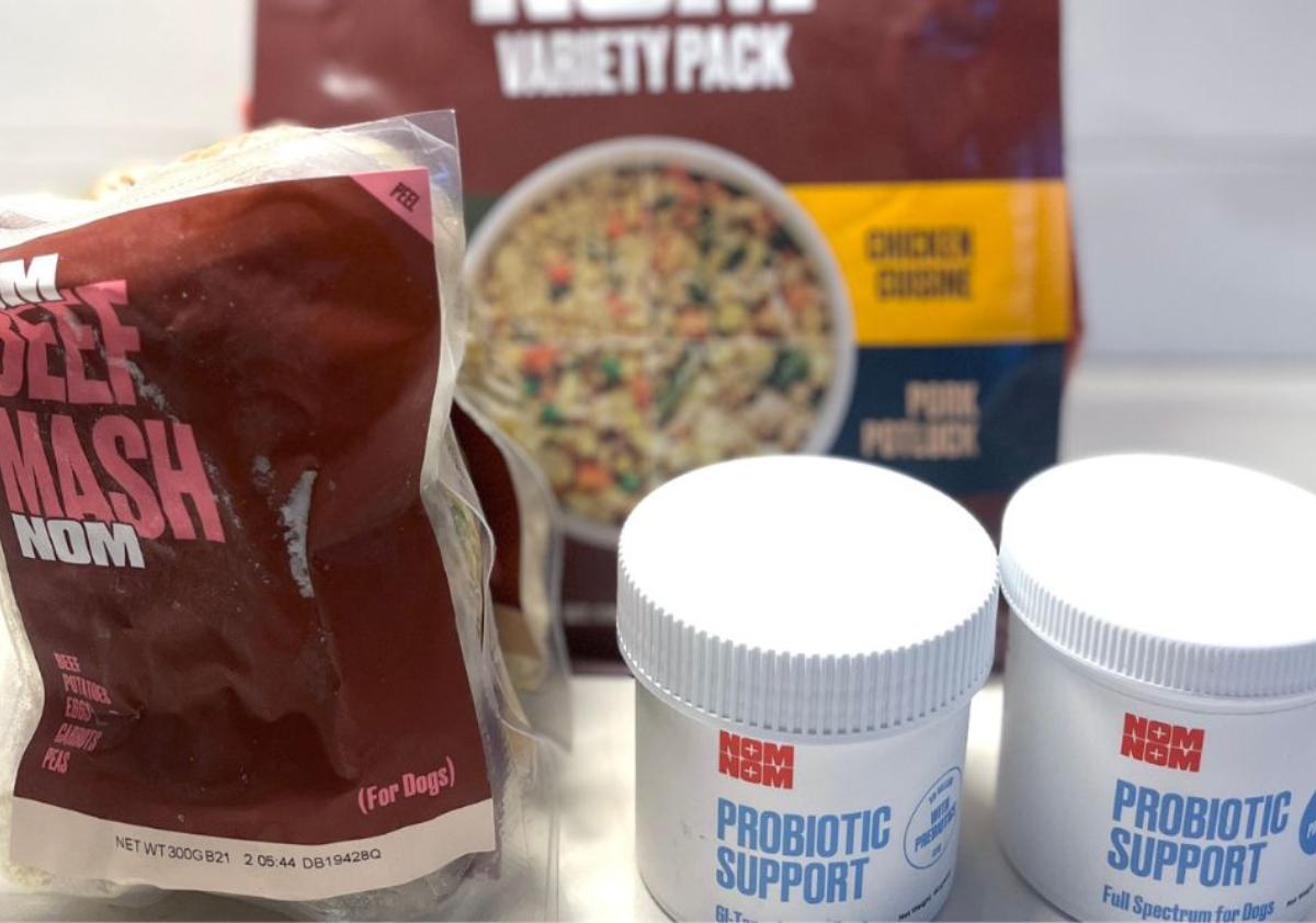 Nom Nom beef food and supplements up close on counter.