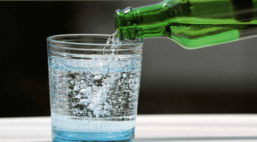 Pouring glass of sparkling water