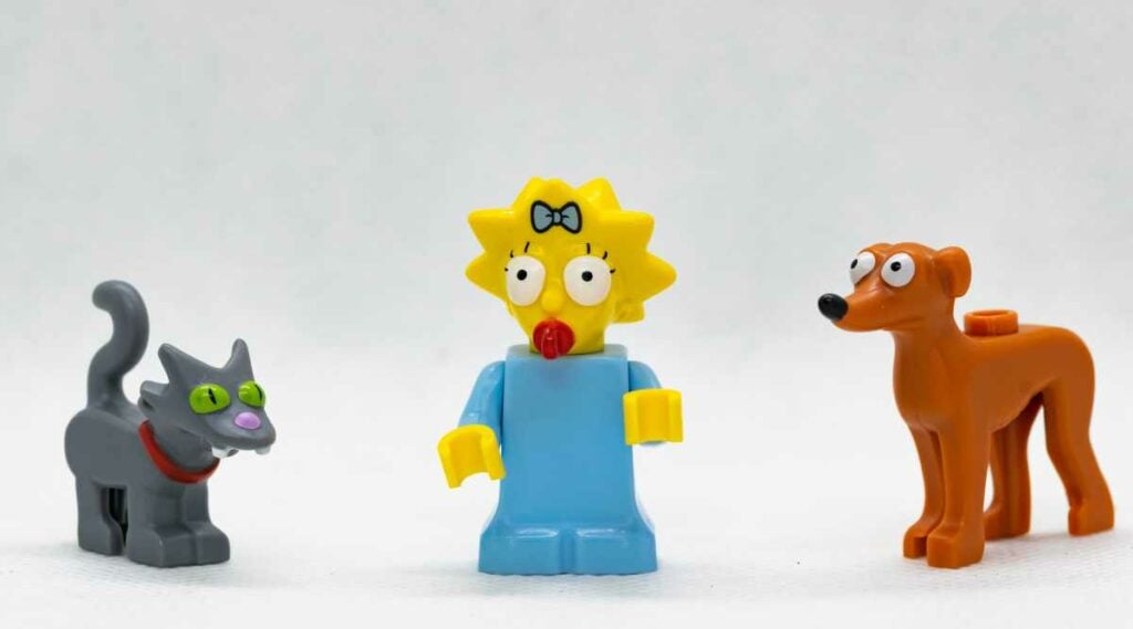 Simpsons Minifigure Maggie Simpson posed with Lego Cat Snowball and Lego Dog