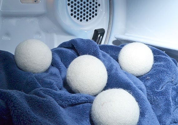 Wool pet hair remover balls bouncing around inside drywer with blanket