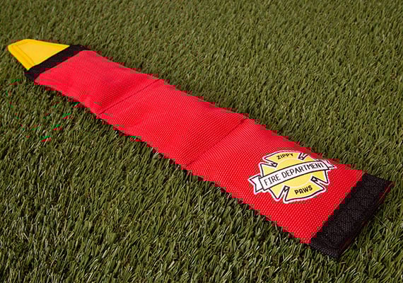 ZippyPaws Firehose Blaster Dog Toy - long fire hose toy sitting on grass