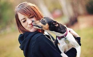 Dog licking woman's face