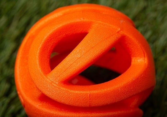 Dog tennis ball with cutouts for easier breathing