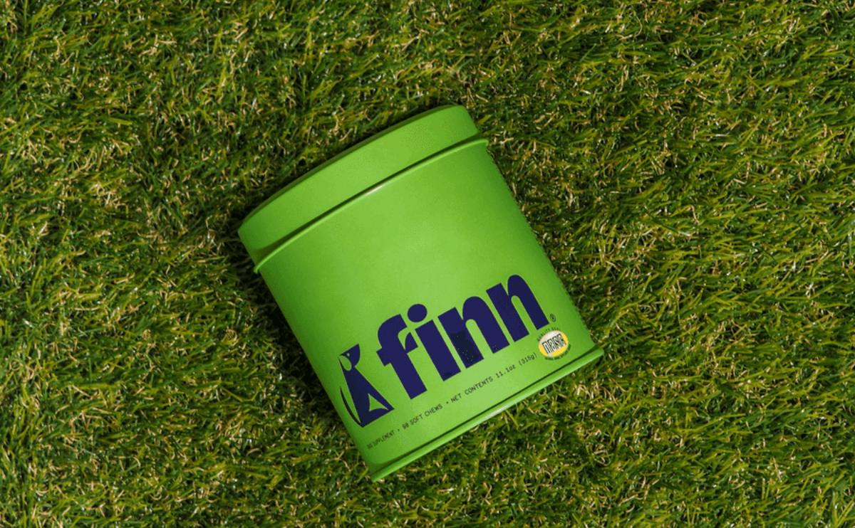 finn dog supplements package in the grass