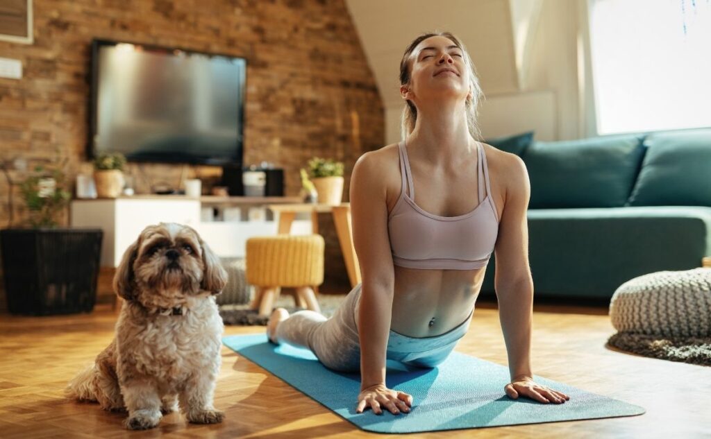 girl doing up dog yoga pose with dog jpg