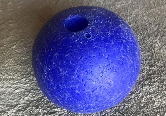 Heavily chewed and punctured ball from Jolly Pet Romp-n-Roll rope and ball dog toy