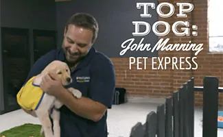 John Manning, General Manager At Pet Express holding puppy (Caption: Top Dog: John Manning Pet Express)