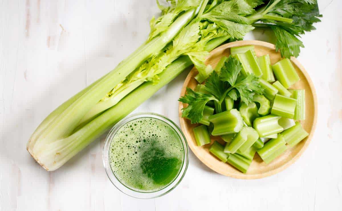 overhead shot of celery on a table with chipped celery and celery juice jpg