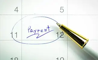 Pen circling "payment" on calendar