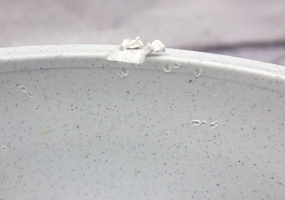 Plastic dog bowl with teeth and scratch marks from Labrador