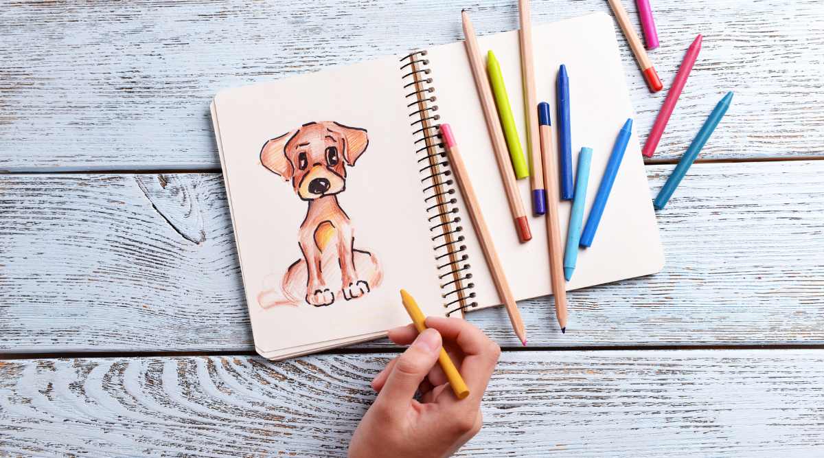 sketching a dog cartoon with colored pencils on a wooden table