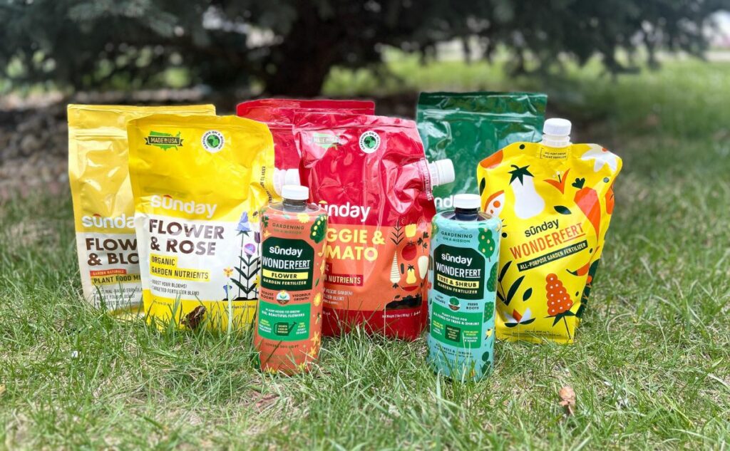 Variety of Sunday fertilizer products in the grass.