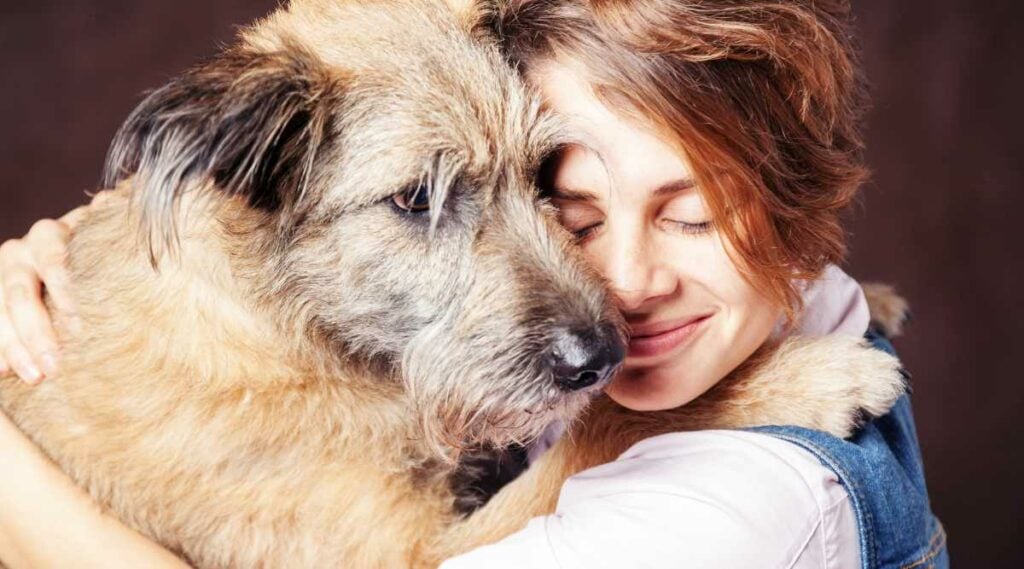 woman embracing a rescue dog
