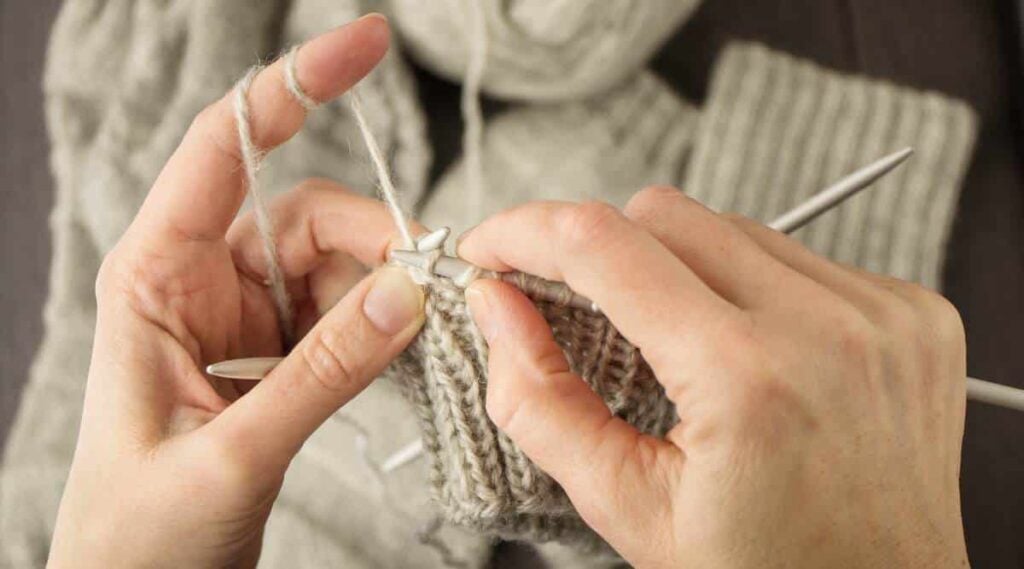 Woman knitting a sweater.